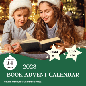 Two children at Christmas reading a book