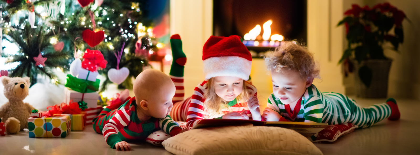 Three children reading a book together