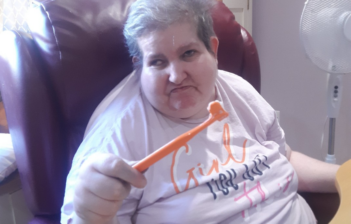 Resident holding a toothbrush