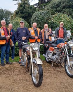 Group of men next to motorbikes