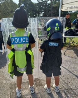 Back of two children wearing police outfits