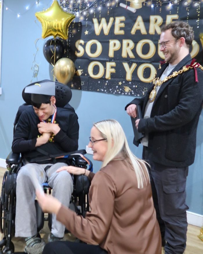 The Mayor and Home Manager present a resident with a certificate