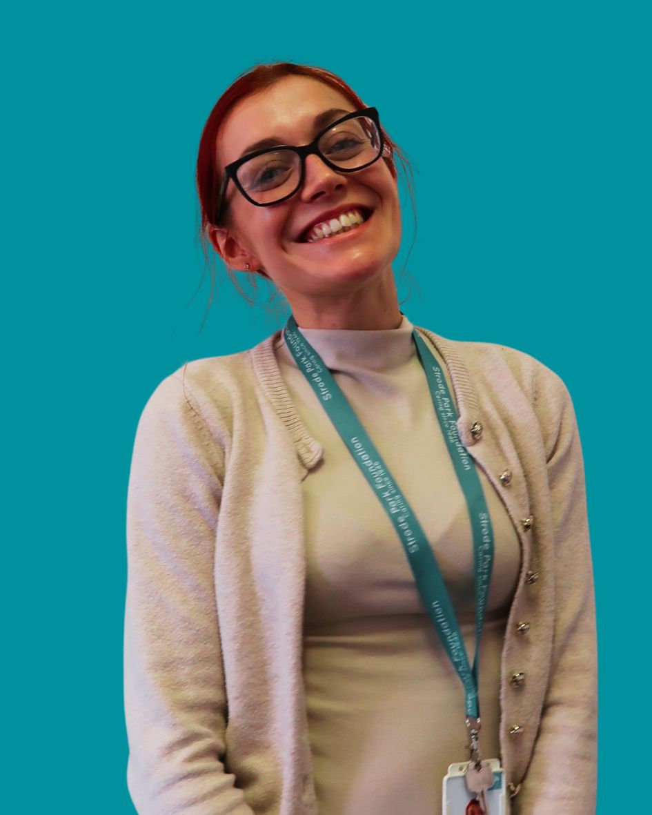 Lady wearing glasses and cream top smiling