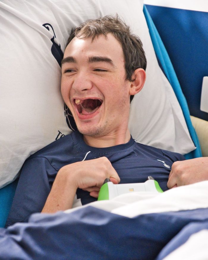 Smiling young male in bed