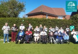 Residents and staff outside holding letters to spell outstanding