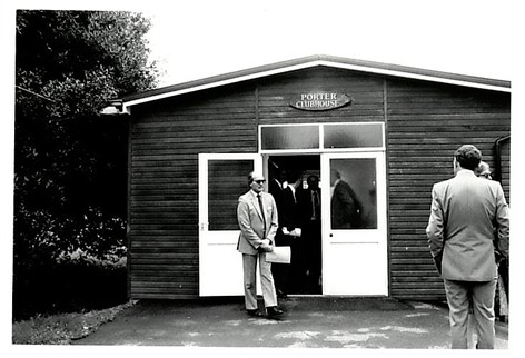 A man standing outside the Porter Club House