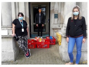 Two people wearing face masks with red shopping crates
