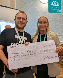 Councillor Josh Rowlands with Claire Dante holding giant cheque